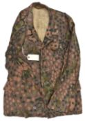 A Third Reich SS four pocket camouflage jacket, with seeded grey metal buttons. GC (some service