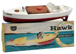 A Sutcliffe clockwork tinplate MINX speed boat/motor launch. In white and red with wooden hatch,
