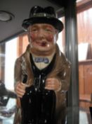 A Royal Doulton Toby jug "Winston Churchill", seated, smoking his habitual cigar, in evening