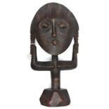 An African stylized darkwood female figure, ovoid face with short pigtails clasped by outstretched