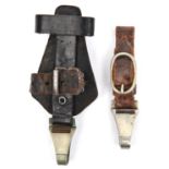 A Third Reich vertical hanger for an SS dagger, of black leather with nickel silver spring clip; and