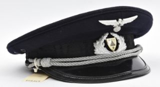 A Third Reich Kyffhauserbund peaked cap, with aluminium cockade and eagle, black band woven with