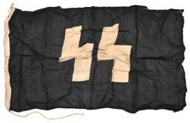 A Third Reich SS flag, 33" x 59", black with white SS runes, the hoist stamped with rectangular
