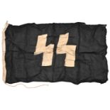 A Third Reich SS flag, 33" x 59", black with white SS runes, the hoist stamped with rectangular