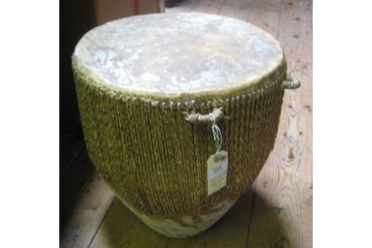 A heavy cup shaped drum, skin covered top with multi cord stretchers to base, diam 14", height