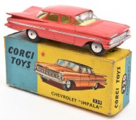 A Corgi Toys Chevrolet Impala (220). In salmon pink with lemon interior. Boxed, some wear. Vehicle