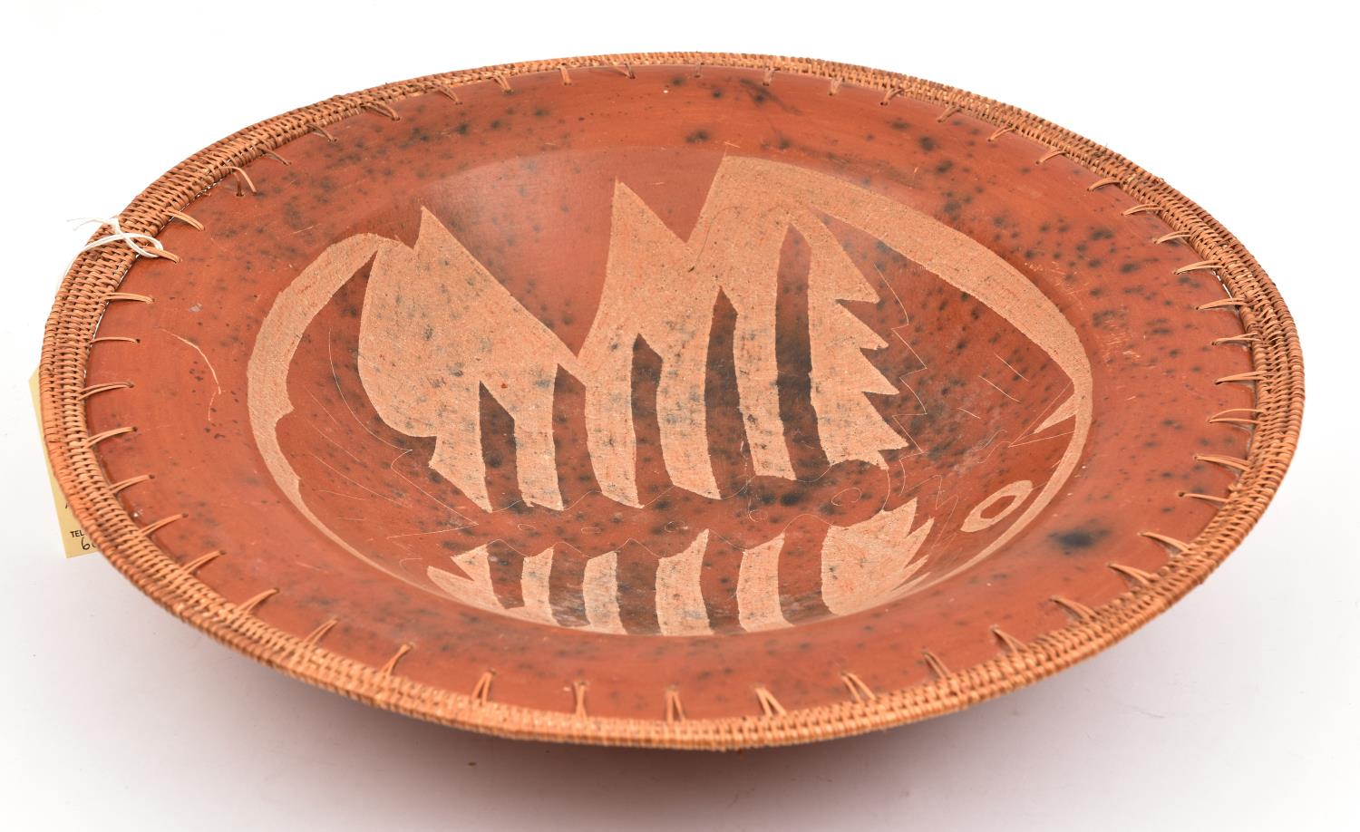 An interesting polished red earthenware dish, with 5/8th" bamboo and raffia work rims, the inside