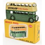 A Dinky Double Deck Bus (290). A Leyland Example in dark green and cream example with DUNLOP adverts