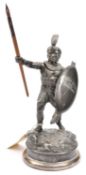 A Vic pewter rowing prize desk ornament, in the form of an African warrior in feathered helmet,