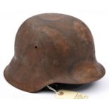 A German M42 steel helmet, with original leather liner and chinstrap, the skull with camouflage
