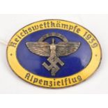 A Third Reich oval pin back blue and yellow enamelled badge, with overlaid N.S.F.K. device, the