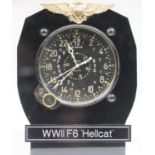 Cockpit clock. Bakelite and aluminium housing with plastic stand. USN wings and label marked WWII F6