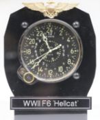 Cockpit clock. Bakelite and aluminium housing with plastic stand. USN wings and label marked WWII F6