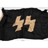 A flag, black with white SS runes, the hoist stamped with RZM/SS mark, “1939”, “85x150” (33½" x 59")