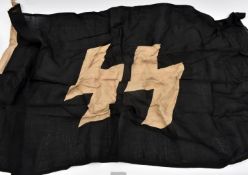 A flag, black with white SS runes, the hoist stamped with RZM/SS mark, “1939”, “85x150” (33½" x 59")