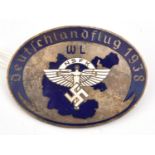 A Third Reich oval pin back enamelled badge, with white NSFK device in the centre with initials “WL”