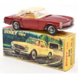 A French Dinky Toys Mercedes-Benz 230SL (516). In metallic red, with cream plastic roof and cream