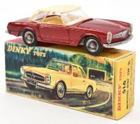 A French Dinky Toys Mercedes-Benz 230SL (516). In metallic red, with cream plastic roof and cream
