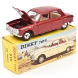 A French Dinky Toys Peugeot 204 (510). In metallic dark red, with cream interior and spun concave