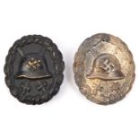 A Third Reich “Spanish” type wound badge in silver (tarnished); and another in black (repainted?).