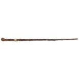 A knotted darkwood walking cane, made in 3 sections, the junction of rootwood grip and haft