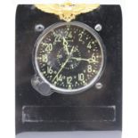 Waltham cockpit clock. Bakelite and aluminium housing with plastic stand. USN wings afixed to stand.