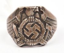 A cast silver coloured finger ring, embossed with German eagle with swept back wings holding a sword