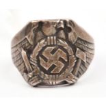 A cast silver coloured finger ring, embossed with German eagle with swept back wings holding a sword