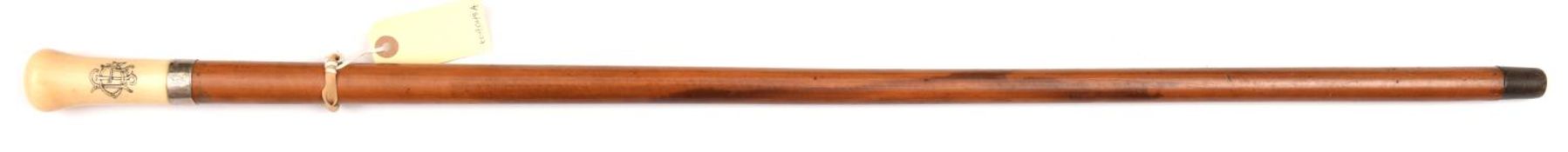 A malacca walking cane, plain silver coloured band to base of ivory grip with monogram “JGL” on