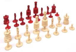 A 19th century ivory/bone chess set. Natural ivory and stained red pieces with threaded joints to