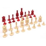 A 19th century ivory/bone chess set. Natural ivory and stained red pieces with threaded joints to