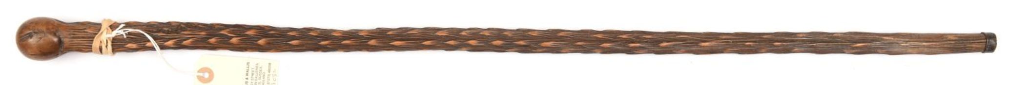 A polished hardwood walking cane, elaborately carved overall in the form of a palm tree stem up to