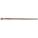 A polished hardwood walking cane, elaborately carved overall in the form of a palm tree stem up to