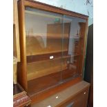 A teak glass sliding bookcase