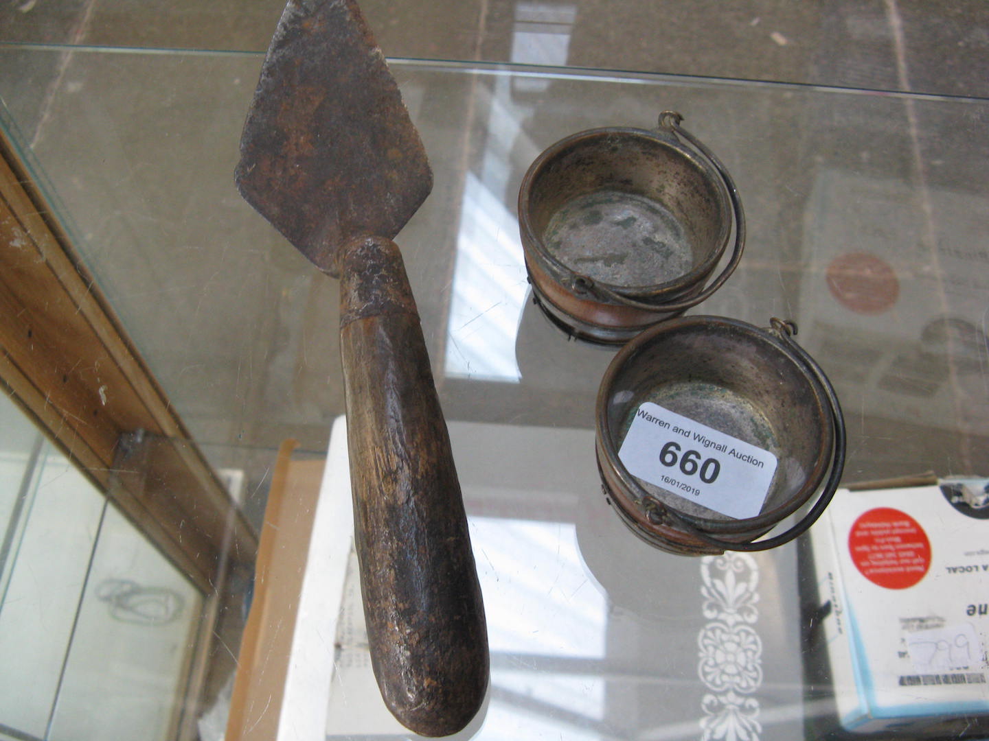 A pair of salts formed as half barrel buckets and a trowel.