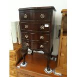 A reproduction mahogany small chest of drawers