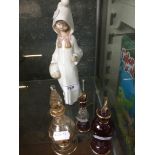 A Lladro figure and 3 scent bottles