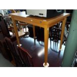 A light wood flip top table