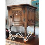 A reproduction oak cabinet with linen fold panels