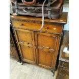 A 1930s oak cabinet with beadwork