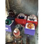 Seven glass paperweights
