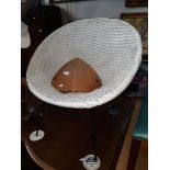 A retro white basket chair.