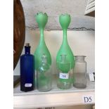 Four small glass bottles and two green glass vases
