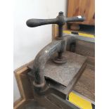 A vintage cast iron paper press