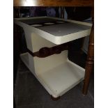 A cream and brown plastic retro drinks trolley.