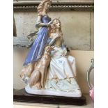 A large porcelain figure of two ladies and a hound