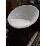 A steel frame and white woven basket chair