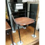 An industrial style steel framed chair with leather seat