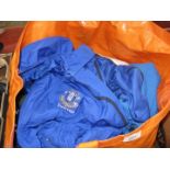 A bag of football shirts and training tops - mainly childrens sizes