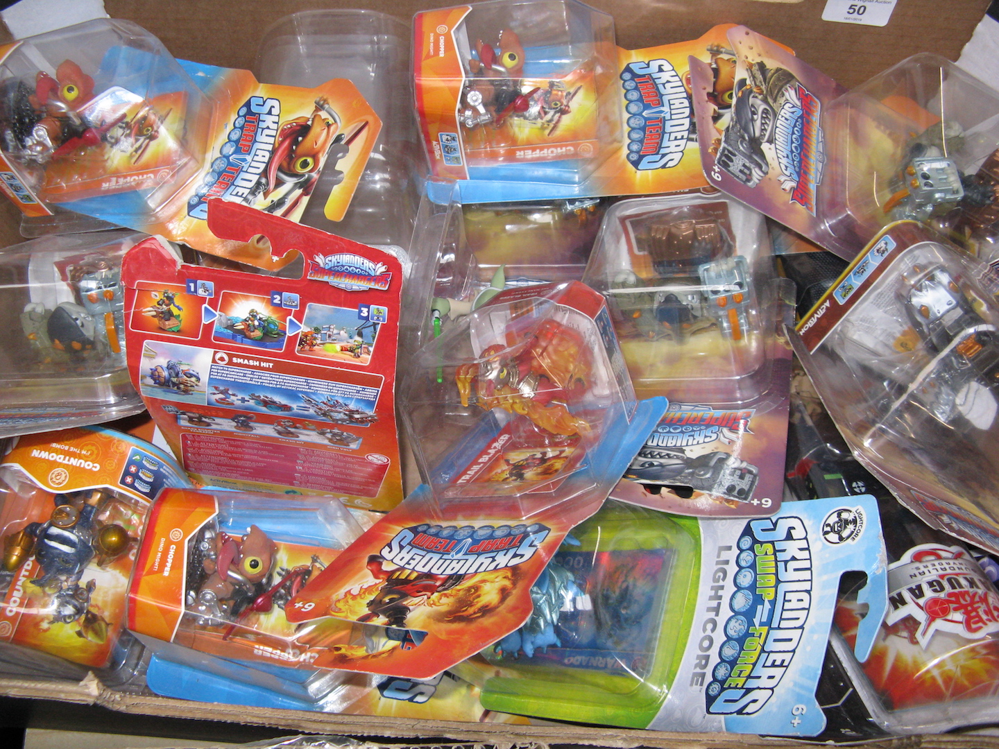 A box containing Skylander figures toys